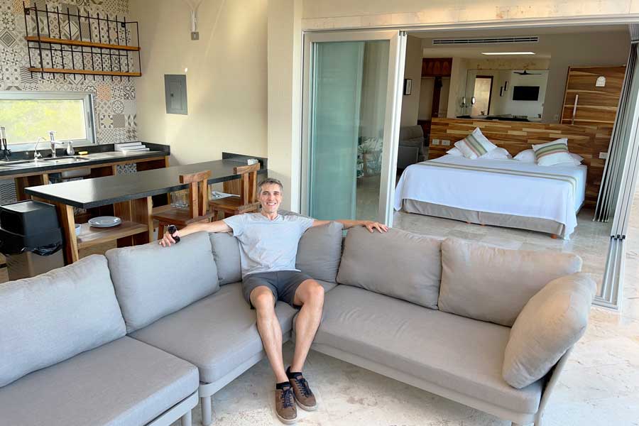 Nate smiling while sitting on a couch in Valhalla Residences by Biwa