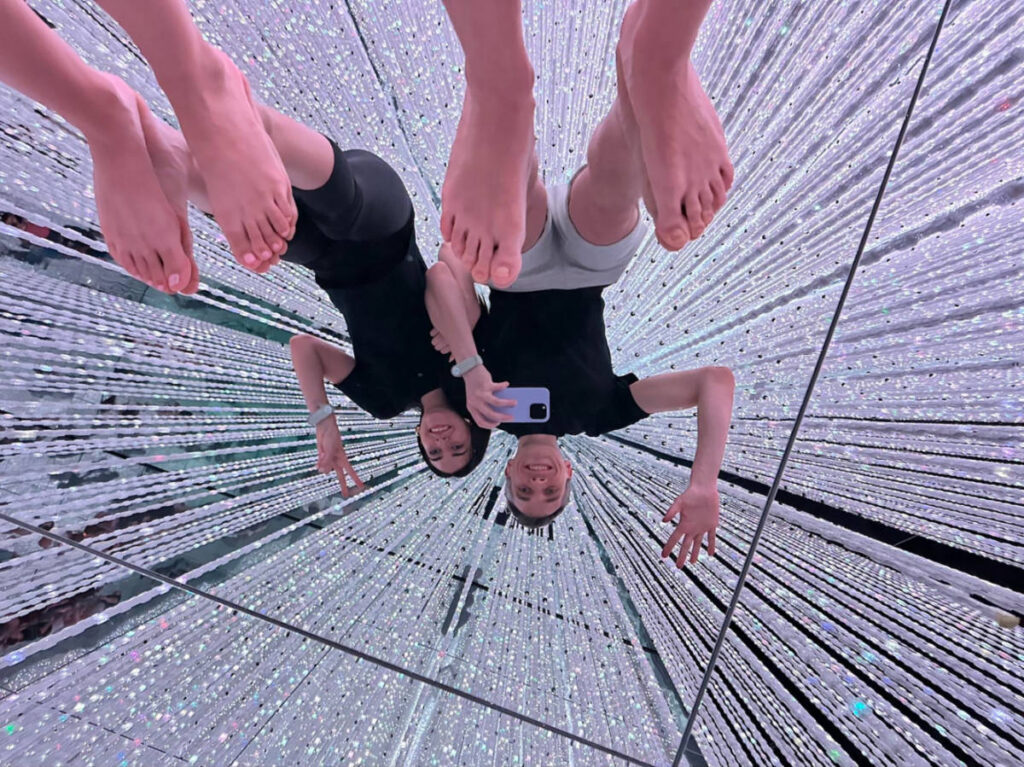 Author Nate and Clara taking a mirror selfie at teamlab Planets
