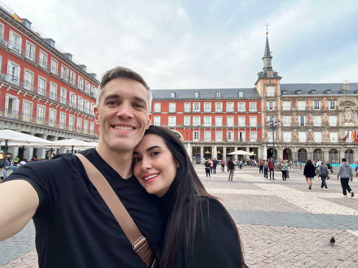 Travel Lemming’s founder Nate Hake and his partner Clara Kesseler smiling for a photo in Plaza Mayor
