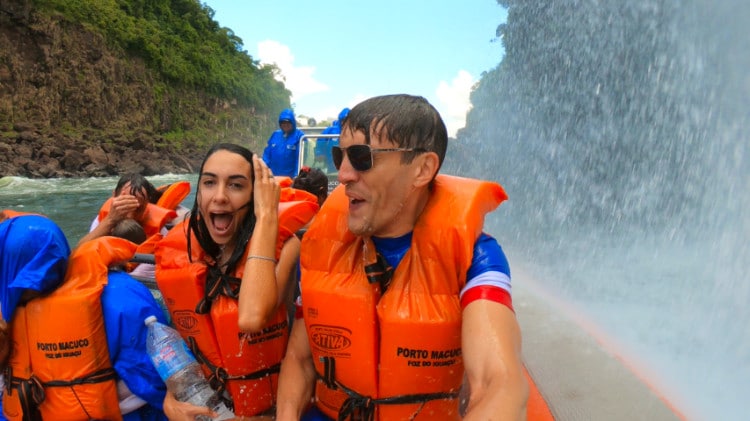 Travel Lemming founder Nate Hake and his partner Clara on the boat under the falls