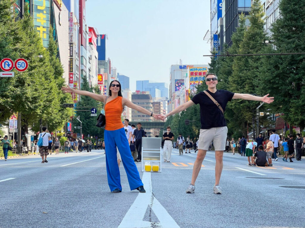 Travel Lemming Founder Nate and Clara happily posing for a photo on the streets of Akihabara