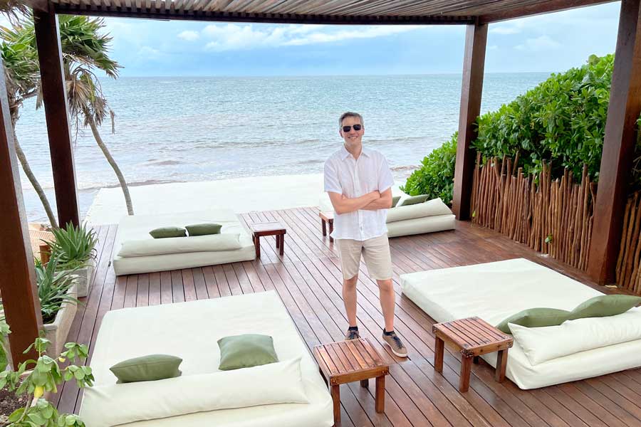 Nate posing for a photo with the beach on his background in Mezzanine