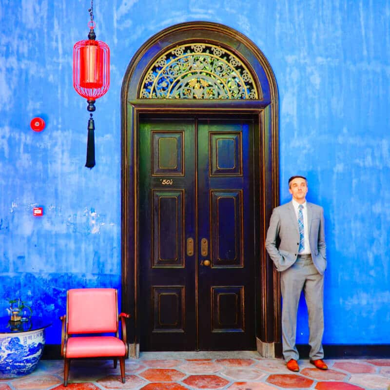 Cheong Fatt Tze's Blue Mansion Author Nate posing for a photo near the door at Cheong Fatt Tze’s Blue Mansion