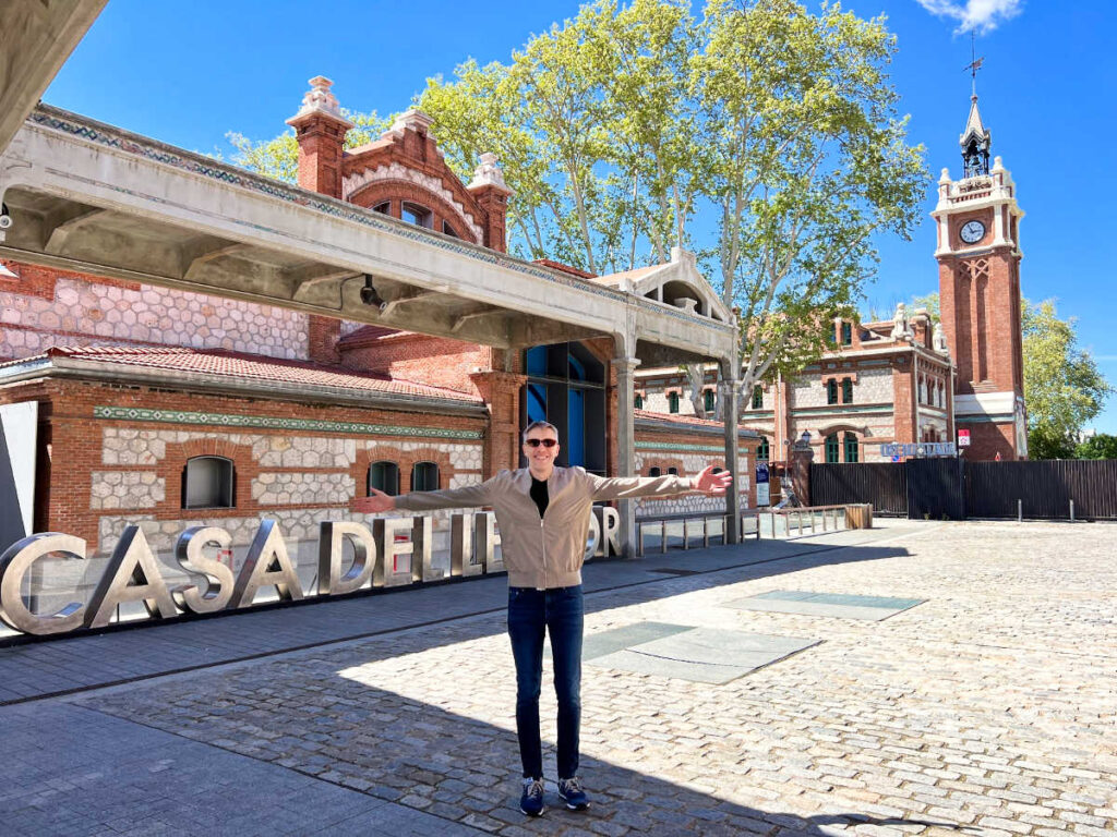 Travel Lemming’s founder Nate Hake posing for a photo in front of the buildings at Matadero Madrid