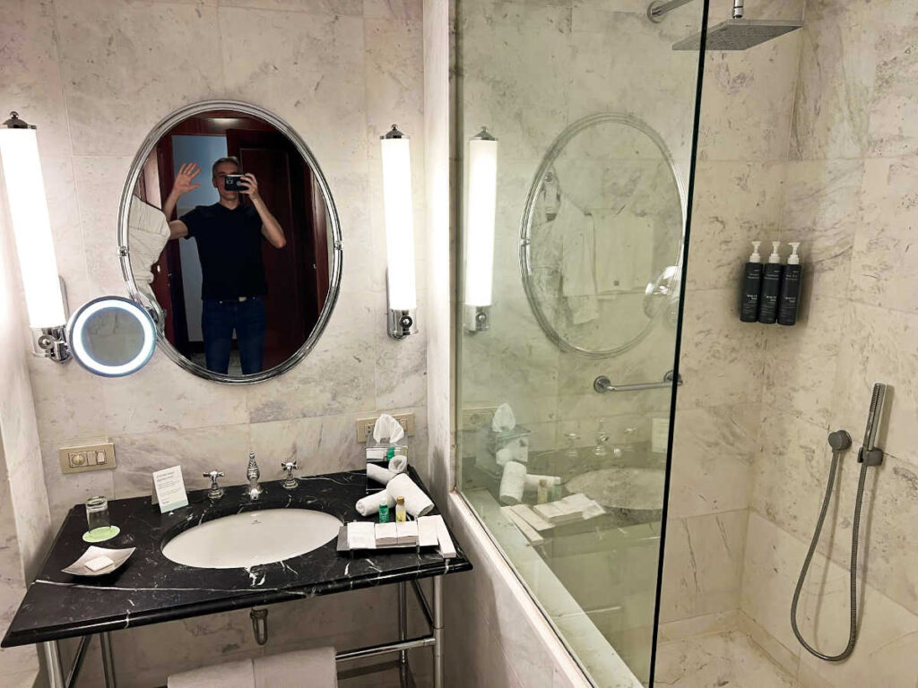 Travel Lemming's Founder Nate Hake, showing off the marbled bathroom at The Westin