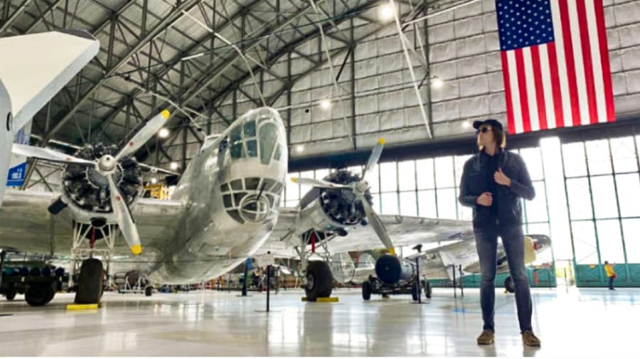 Travel Lemming founder Nate Hake posing near the aircraft inside Wings Over the Rockies Air & Space Museum