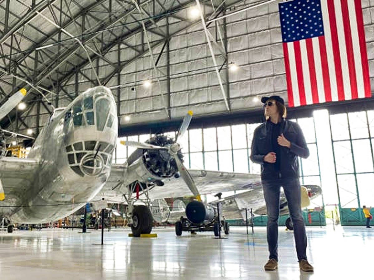 Travel Lemming founder Nate Hake posing near the aircrafts inside Wings Over the Rockies Air & Space Museum
