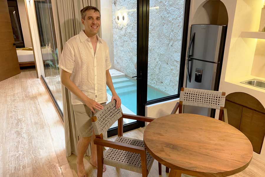 Nate smiling for a photo inside their room in Eterna Tulum