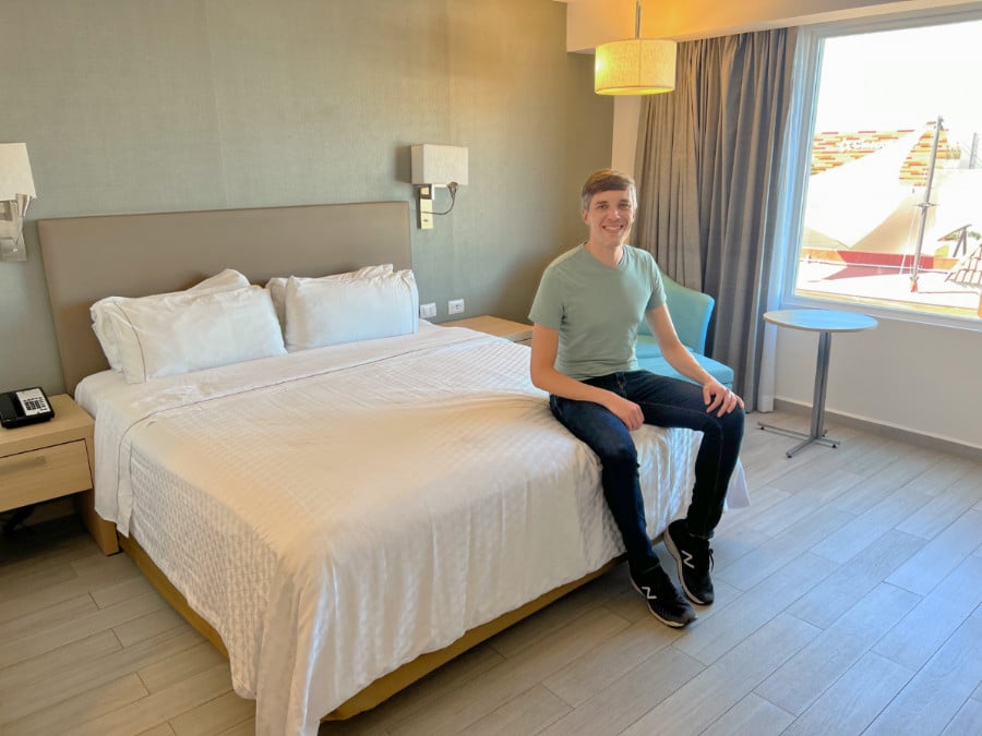 Nate sitting on a bed in Fiesta Inn La