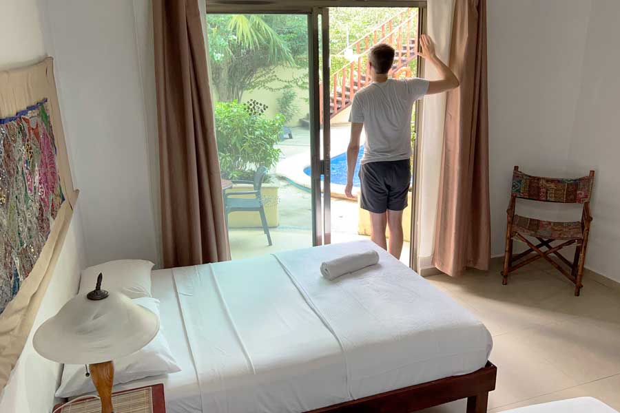 Nate standing on the door frame going to the pool area in Hotel Villas Akalan