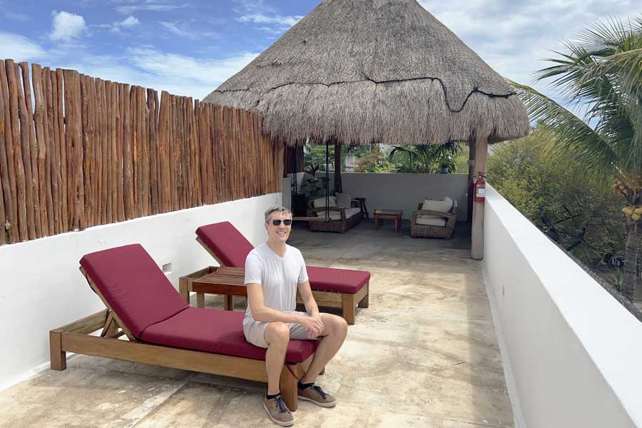 Nate sitting on a chair at the rooftop of Kin Ha Tulum