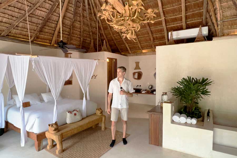 Nate posing for a photo inside a bedroom in La Valise Tulum
