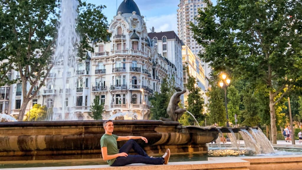 The author Nate Hake, posing near the fountain in Spain