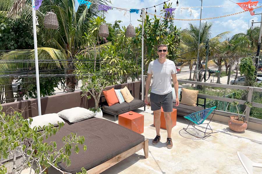 Nate standing for a photo at a rooftop in Teetotum Hotel