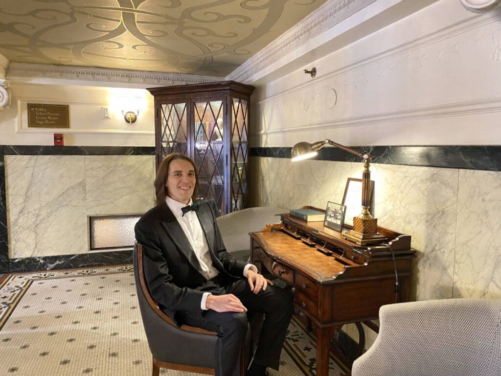 The author, Nate Hake smiling for a photo in The Oxford Denver Hotel
