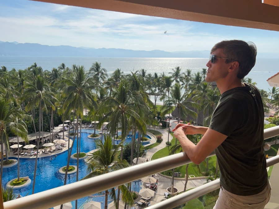 Nate admiring the view from the balcony of their room in Westin Puerto Vallarta