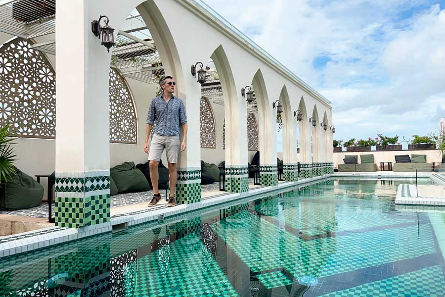 Nate posing for a photo beside the pool in Layla Tulum