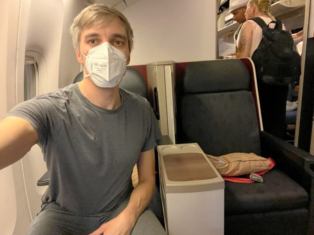 The author in a mask on a plane