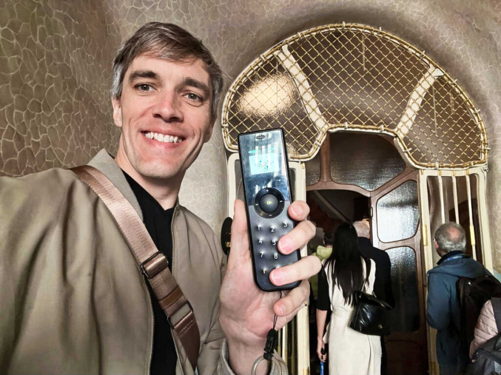 Travel Lemming Founder Nate Hake, showing off the audio tour device in Casa Batllo