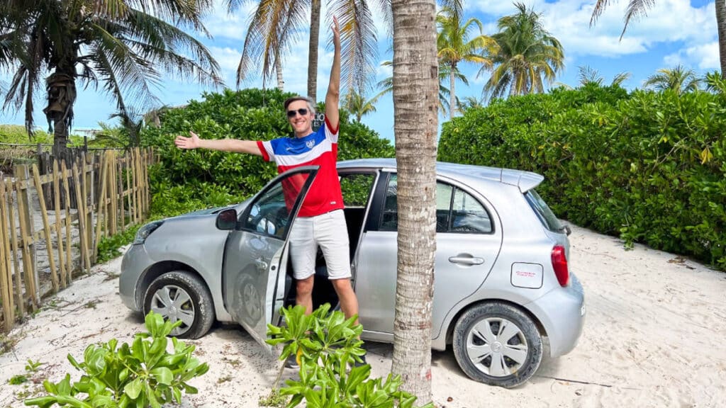 The author Nate Hake, posing outside a rental car in El Cuyo