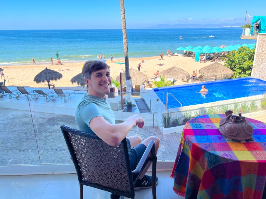 Nate with the view of the pool and ocean in Vallarta Shores
