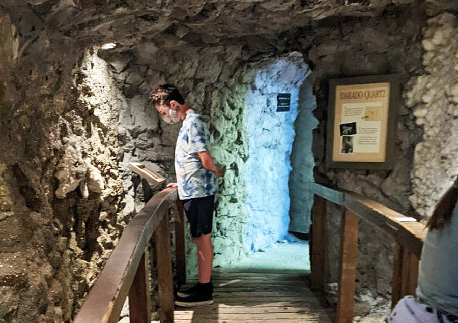 A boy reading some facts about the National Mining Hall of Fame and Museum