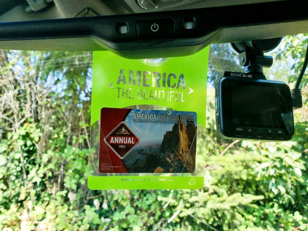 A National Park Pass hanging inside the car