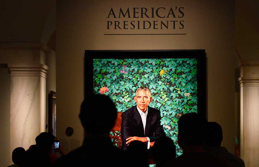 People looking at a portrait of Barack Obama in National Portrait Gallery