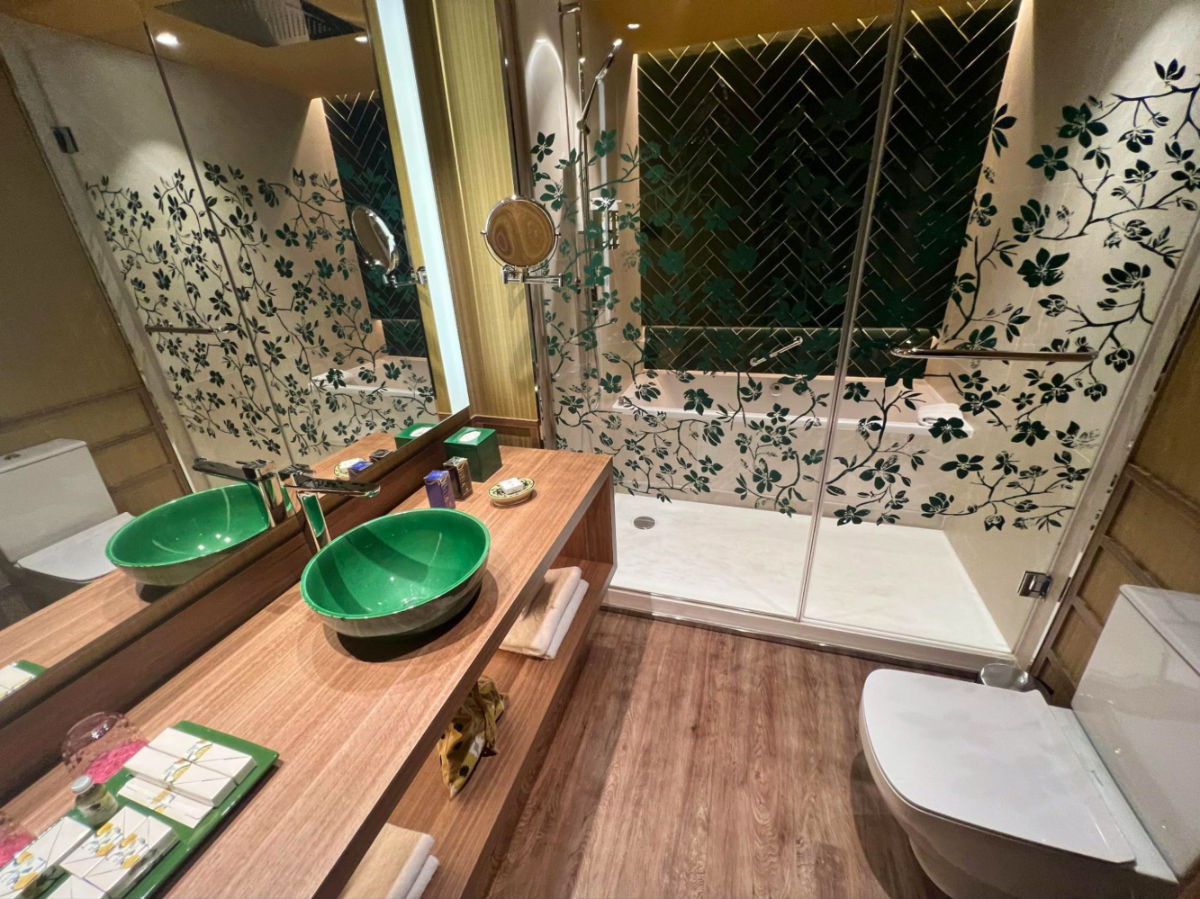 Bathroom with a tub and massive rain shower and green sink in Querencia de Sevilla hotel