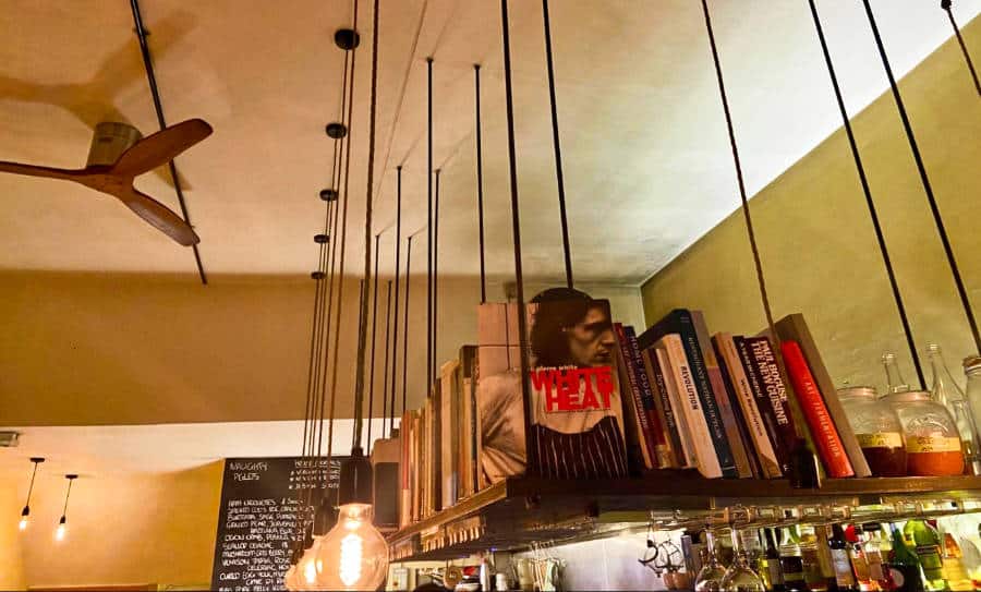 Stunning interior with books on a floating shelf in Naughty Piglets.