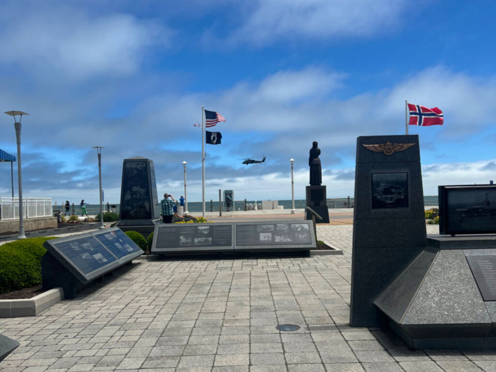 View of Naval Aviation Monument Park on a sunny day with a Helicopter flyby
