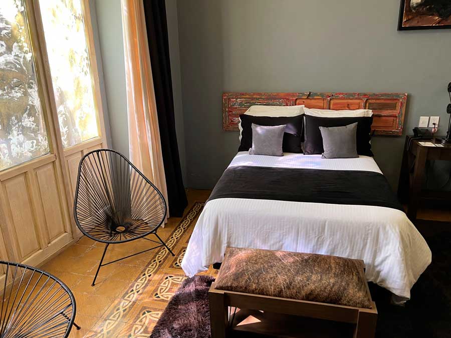 View of a bed from a bedroom in Nena Hotel Boutique