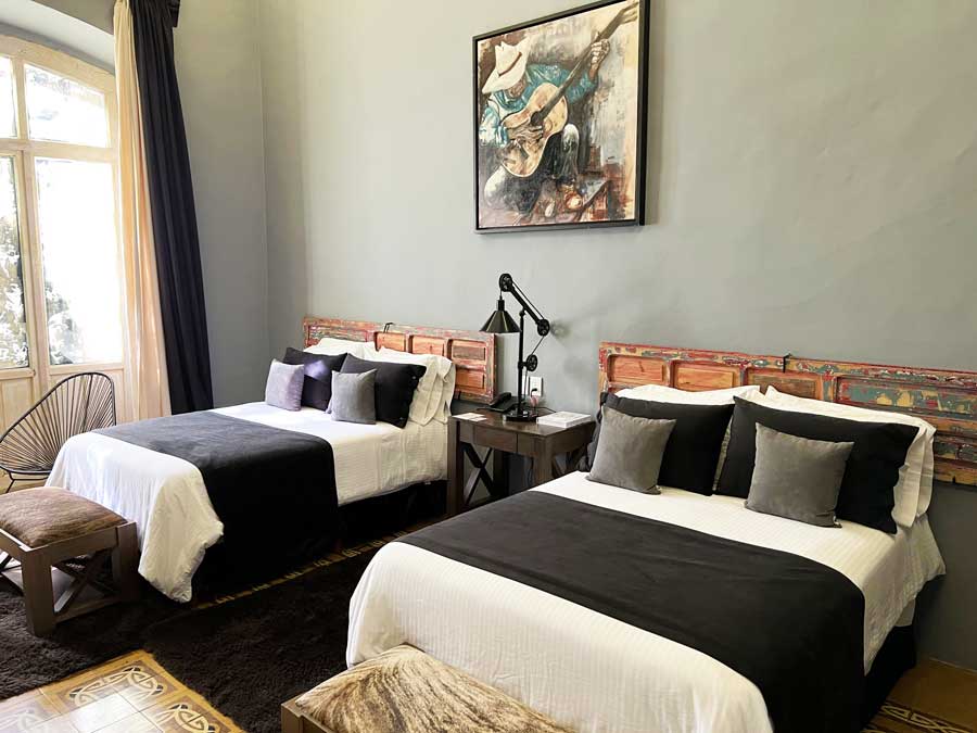 View of two single beds in Nena Hotel Boutique