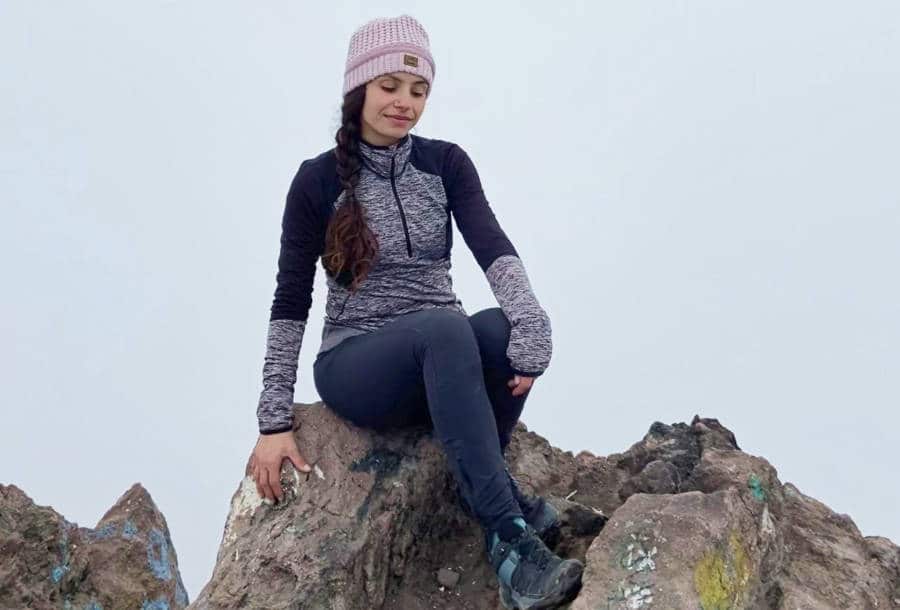 The author McKenna Mobley posing at the summit of Nevado de Toluca on a cloudy day