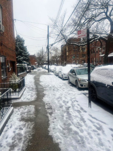 Cars parked along the road covered with snow during winter season