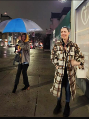 The author Niamh walking on a rainy night