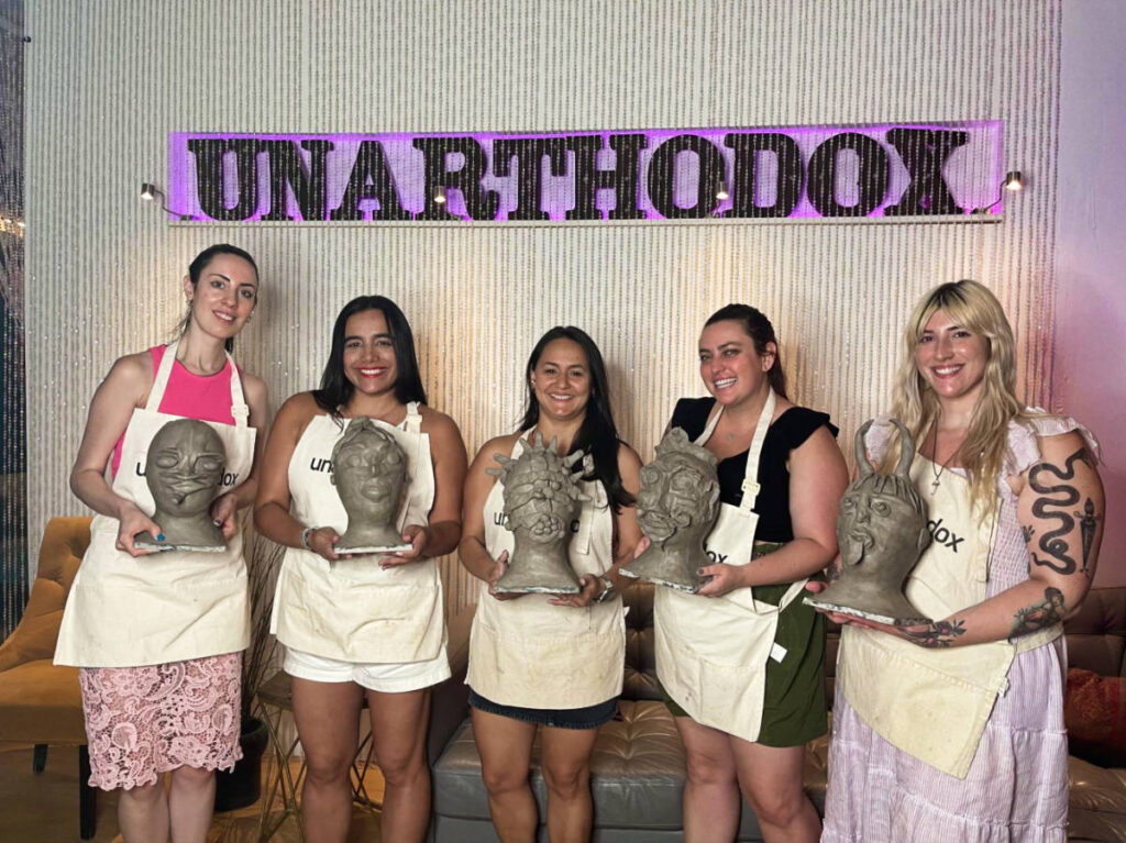 The author Niamh Hayes and her friends, holding sculpture artwork at Unarthodox