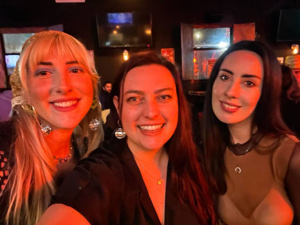 The author Niamh Hayes and her friends, smiling for a photo at the Murphy’s Sports Bar