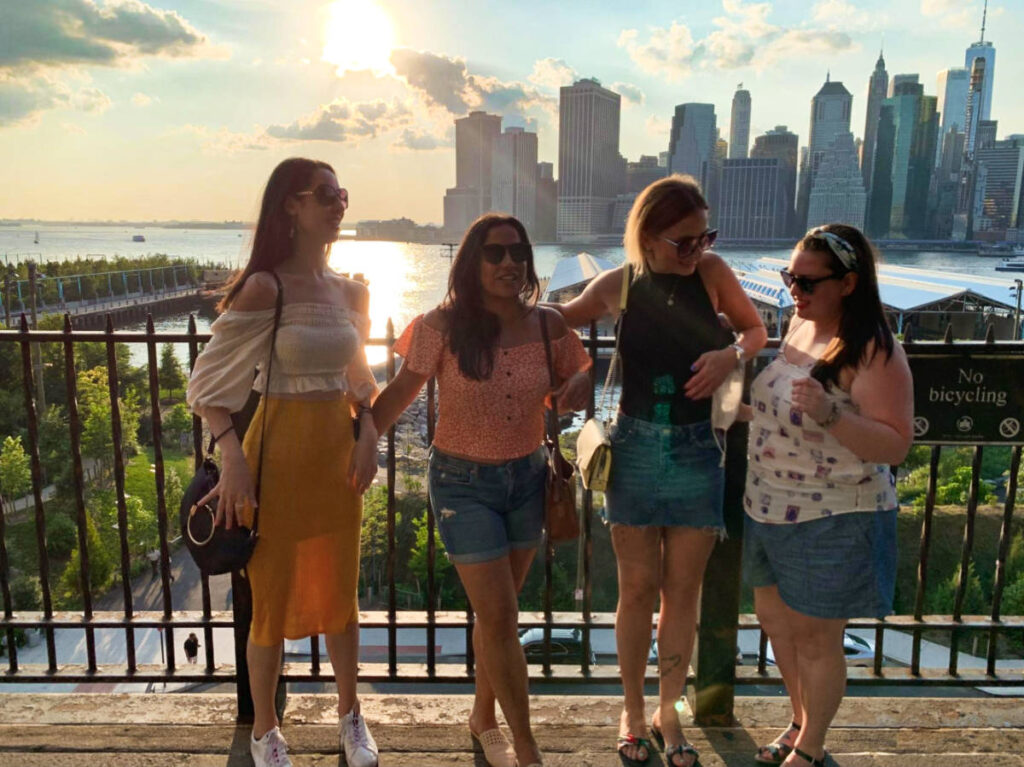 The author Niamh Hayes and her friends, posing for a photo in Dumbo at sunset