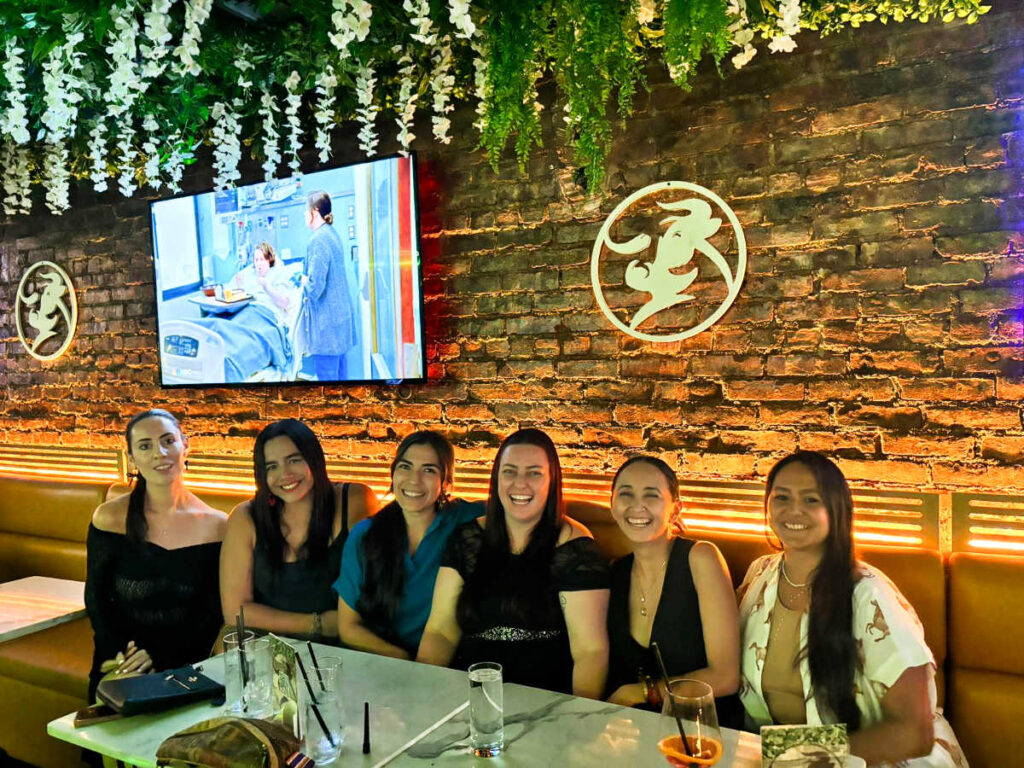The author Niamh Hayes and her friends sitting inside Smeat & hueso