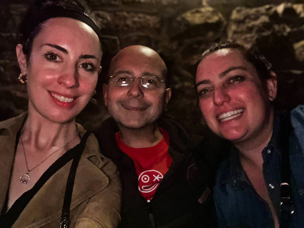 The author Niamh Hayes and her friend, taking a photo with a local in Krakow
