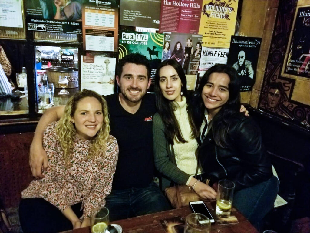 The author Niamh Hayes and her friends, posing for a photo inside a pub