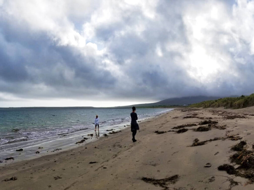 The author Niamh Hayes and her friend enjoying along the sandy Castlegregory Beach