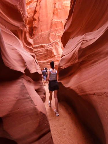 The author Niamh Hayes walking along the narrow pathway in Lower Antelope Canyon