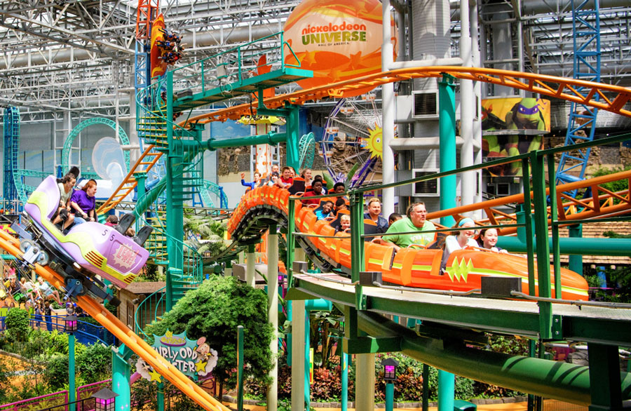 View of kids and adults enjoying the rollercoaster ride in Nickelodeon Universe