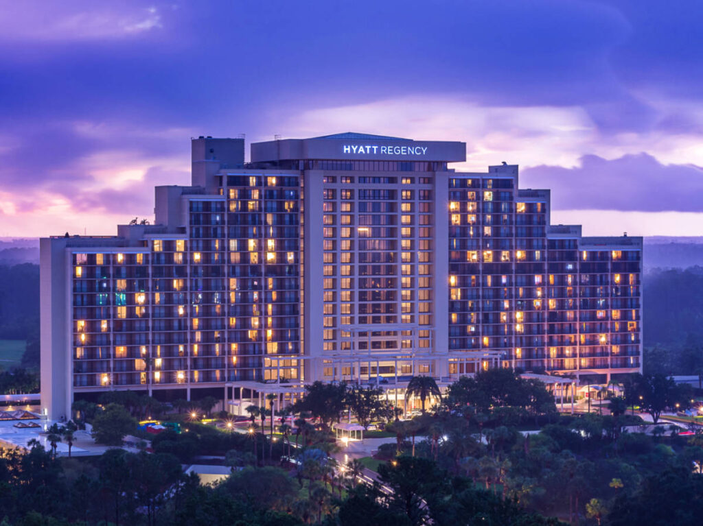 Exterior view of the illuminated Hyatt Regency Grand Cypress hotel at dusk