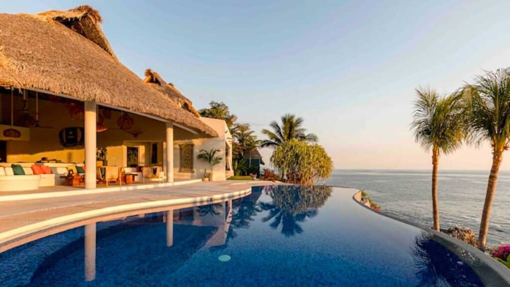 The pool area in Night of the Iguana accommodation with beach view