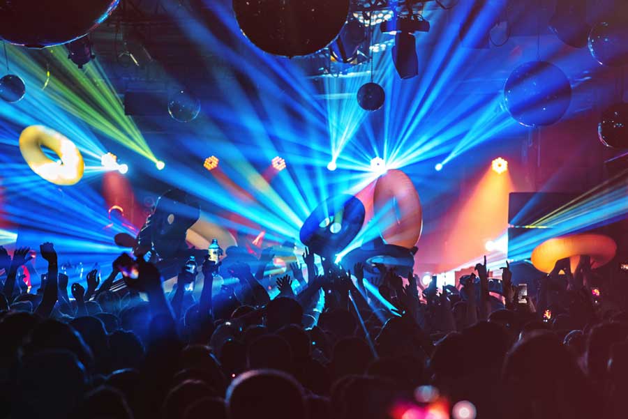 People enjoying their night dancing at a nightclub