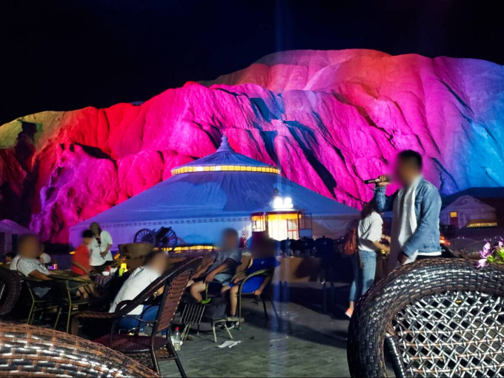 People enjoying the night with rainbow mountains view