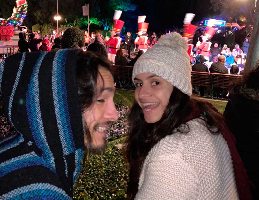 The author with her brother watching a nighttime parade in Disneyland
